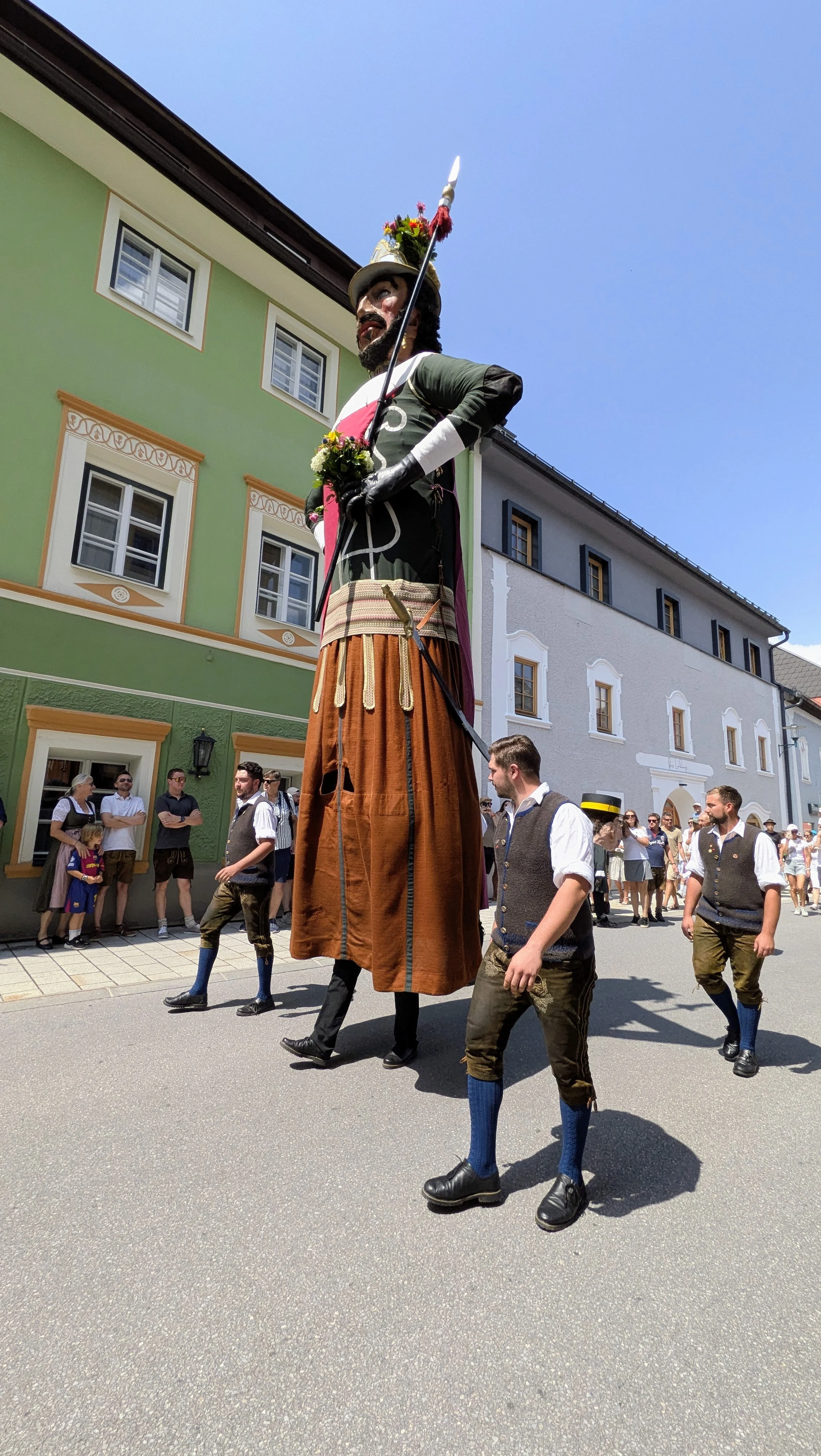 Samson giant carried through Tamsweg street procession with onlookers
