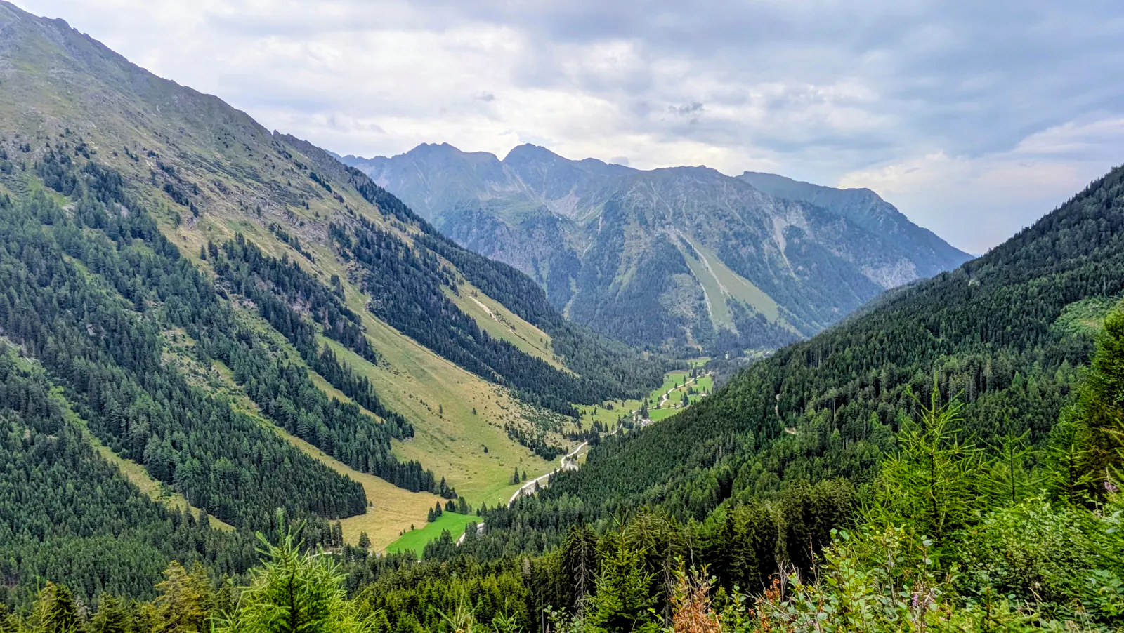 Wide mountain panorama above the naturally winding Longa stream in the Weisspriachtal valley