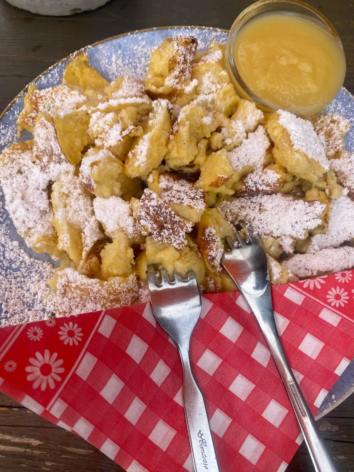 Kaiserschmarrn dusted with powdered sugar and served with apple sauce at Tonimörtlhütte.